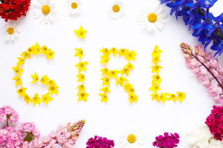 Word  GIRL written with garden flowers on whiteの写真素材