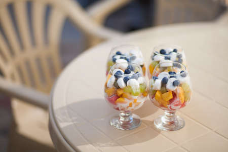 Fruit salad in a glass cup, on a table in caffee houseの写真素材