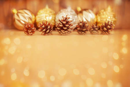 pine cones on wooden background, magic garland light, copyspaceの写真素材