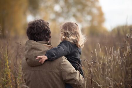 Father and his little daughter together in the field, single parentの写真素材