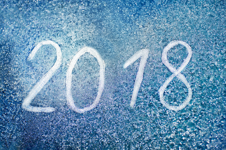 The inscription 2018 on the frozen glass, new year concept backgroundの写真素材
