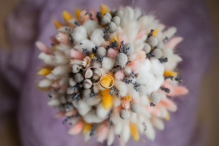 Wedding rings on bouquet of dry flowers, rustic style, autumn. Pastel colorsの写真素材