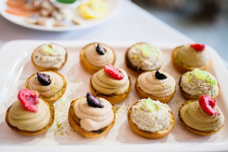 Wedding appetizer. Fruit dessert sandwiches served on the table, cateringの写真素材