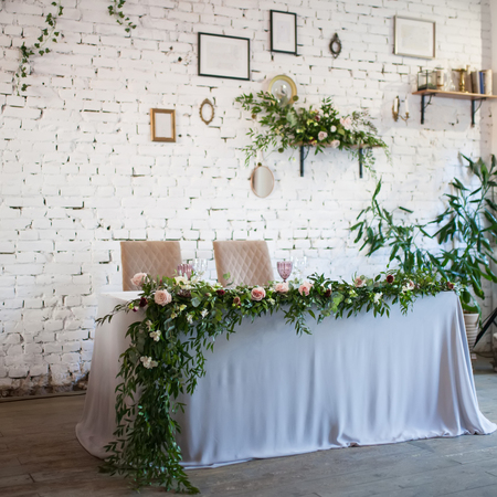 Wedding table decorated with flowers, greenery style, closeup photo. Loft styleの写真素材