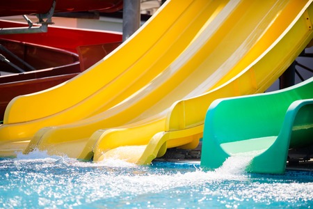 Green and yellow slides in the water park (aquapark), close-up.の写真素材