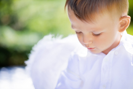 Adorable toddler boy in angel costume, angelic child. Saint Valentines day.の写真素材