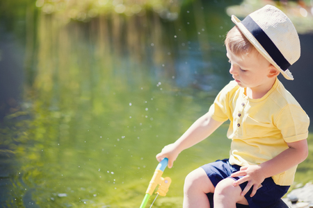 Toddler boy fishing in the lake. Summer dayの写真素材