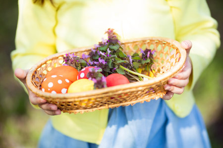 Close up of colorful Easter eggs in a basket at child's hands