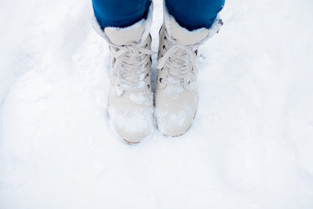 White boots in the snow, closeup
