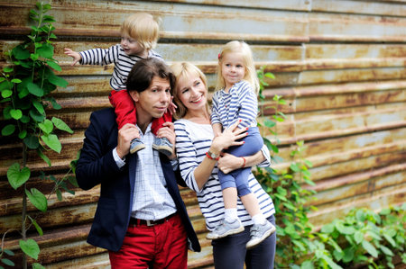 Outdoor portrait of a amazing family walking together in forest park