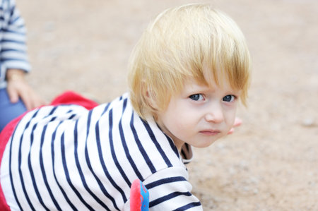 Close-up portrait of cute baby boy posing outdoorの写真素材