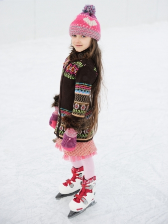 Little girl having fun on ice skating rink outdoorsの写真素材