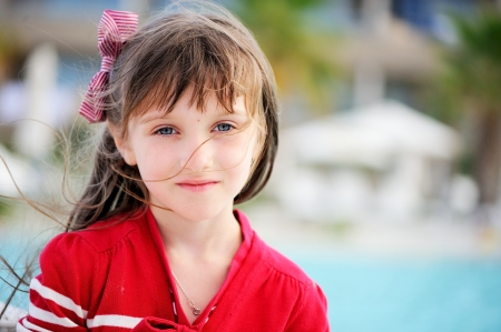 Portrait of serious little girl in white hat and sunglassesの写真素材