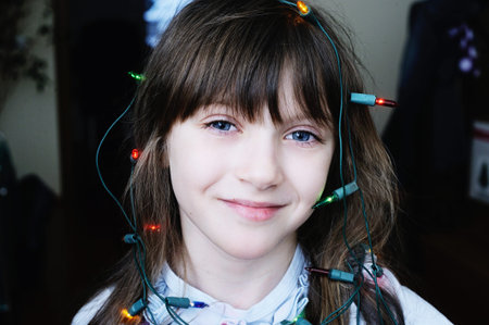 Beauty kid  girl being happy about christmas tree and lights.の写真素材