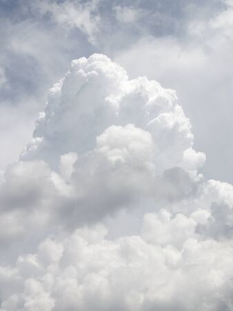 Cumulus clouds against cirrus clouds and blue skyの写真素材