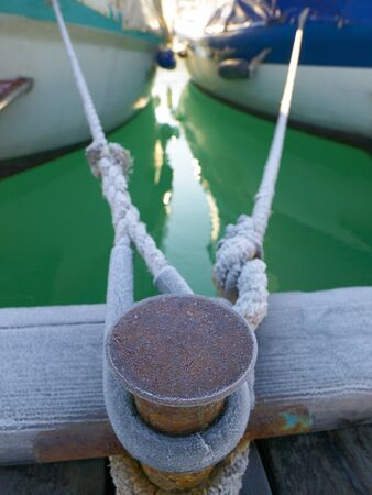 Bollard with two ropes from yachtsの写真素材