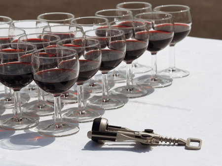 Wineglasses with red wine and the corkscrew