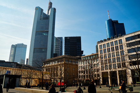Frankfurt am Main, Germany - March 16, 2017: Goetheplatz with walking people, old buildings and modern skyscrapers against the blue sky in the morningのeditorial素材