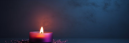 Candle flame on dark background with copy spaceの素材