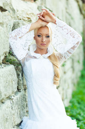 Beautiful portrait of sensual bride near old castleの写真素材