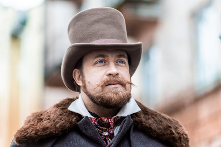 Respectable mustachioed man in classic retro clothes, coat and hat.の写真素材