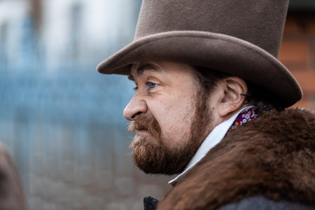 Respectable mustachioed man in classic retro clothes, coat and hat.