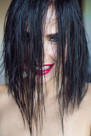 Beautiful young woman portrait wet hair and red lipsの写真素材