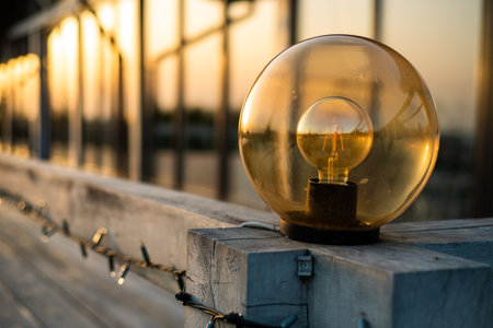 Light bulb on the wooden bridge in the evening light with copy spaceの写真素材