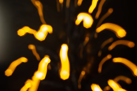 abstract yellow bokeh lights on black background, defocused
