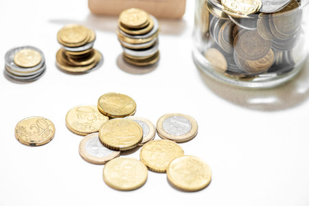 Coins in the glass jar on white background. saving concept.