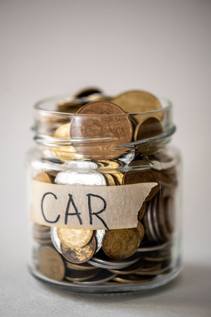 Coins in a glass jar with the label CAR. financial conceptの写真素材