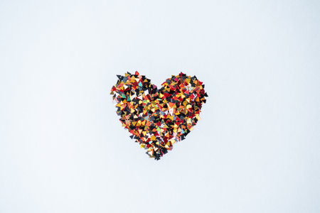 Heart shape made of confetti on white background. Valentine's day concept.の写真素材