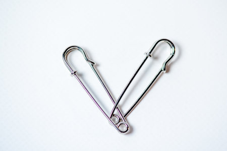 Safety pin on a white background. Copy space for your text.の写真素材