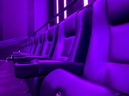 Cinema seats in purple neon light. 3d rendering.