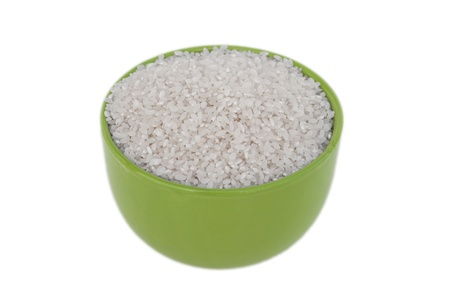 Bowl of uncooked rice on a white backgroundの写真素材