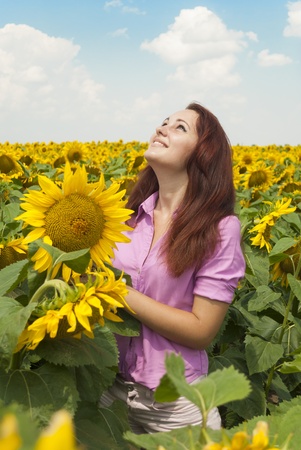 Beautiful girl in a field of sunflowers.の写真素材