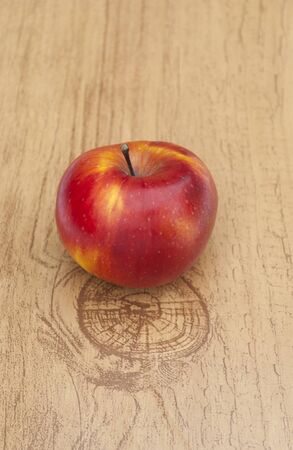 Red ripe apple on a wooden tableの写真素材