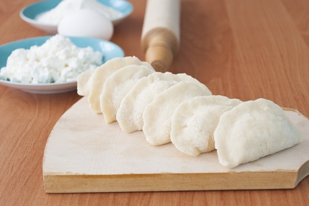 Uncooked dumplings on the cutting boardの写真素材