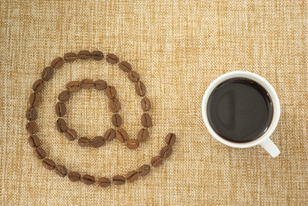 Cup of coffee and email sign.の写真素材