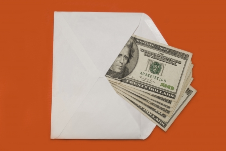 Envelope with dollars lying on a red backgroundの写真素材