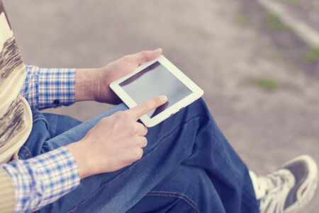 Man with tablet in hand on the street.の写真素材