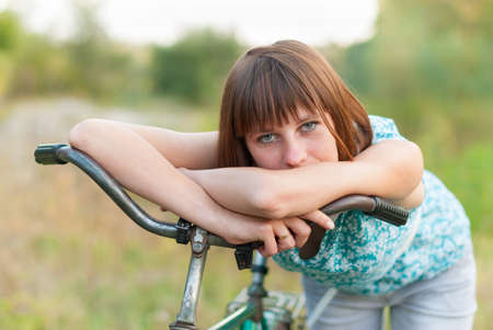 Beautiful girl with an old bicycle.の写真素材