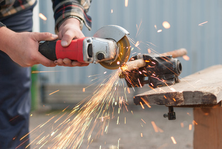 Man cuts a metal pipe power saw.の写真素材