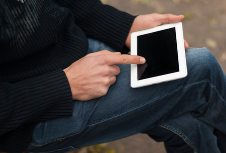 Man with a tablet in his hand close-up.