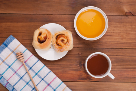 Tea with honey and cookies on the kitchen table.の写真素材