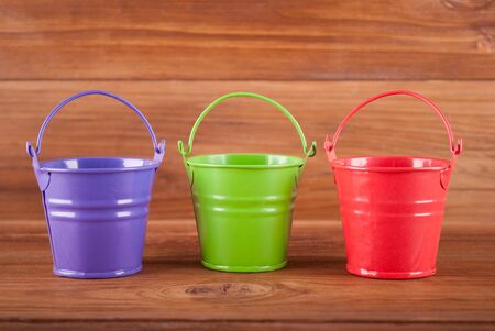 Beautiful buckets on the wooden background.の写真素材