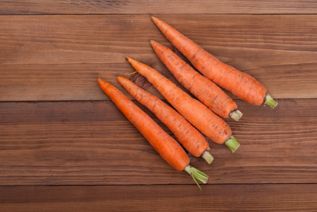Carrot on wooden background.