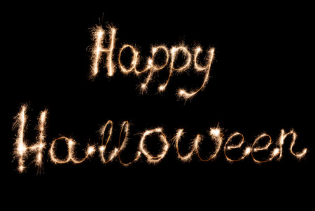 Inscription Sparklers Happy Halloween on a dark background.の写真素材
