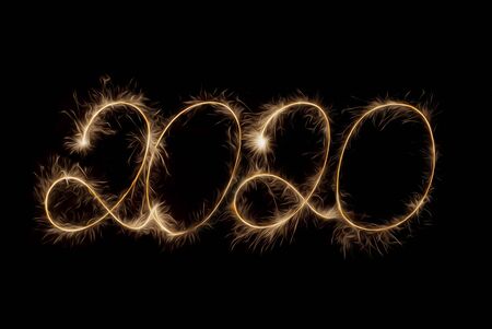 2020 inscription with sparklers on a black background.の写真素材
