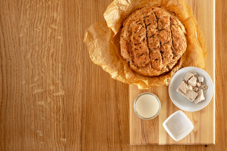 yeast for baking. Dry yeast, pressed yeast and homemade yeast (sourdough) on an oak table next to...